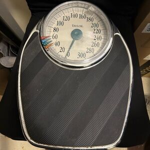 Old vintage Taylor brand analog bathroom scale with a 300 lb capacity